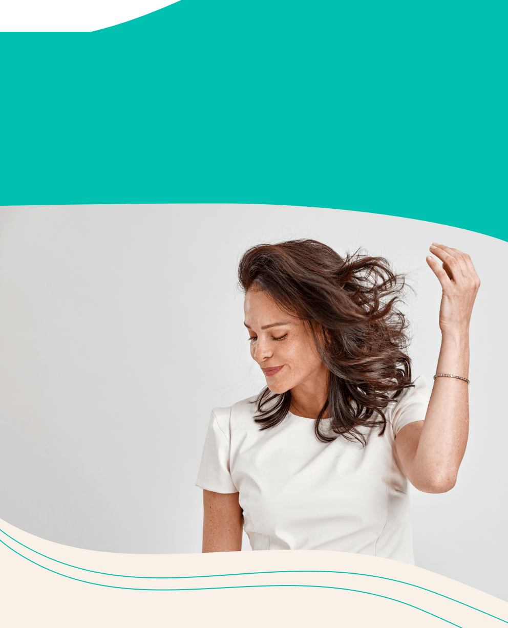 A woman enjoys her beautiful hair.